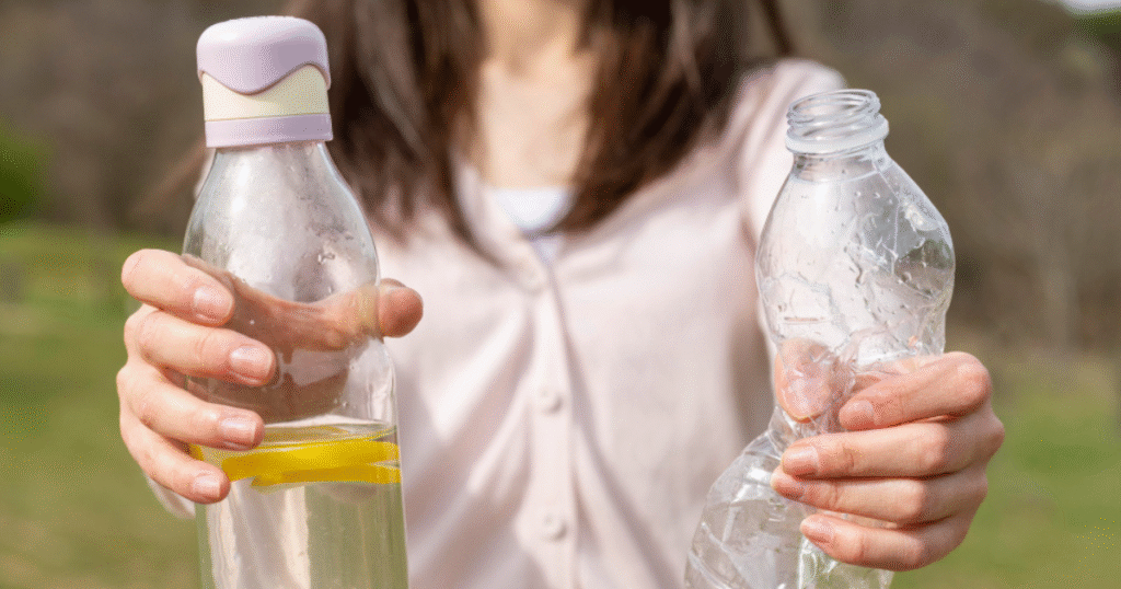 A woman holds two empty plastic bottles, demonstrating a focus on recycling and environmental awareness.