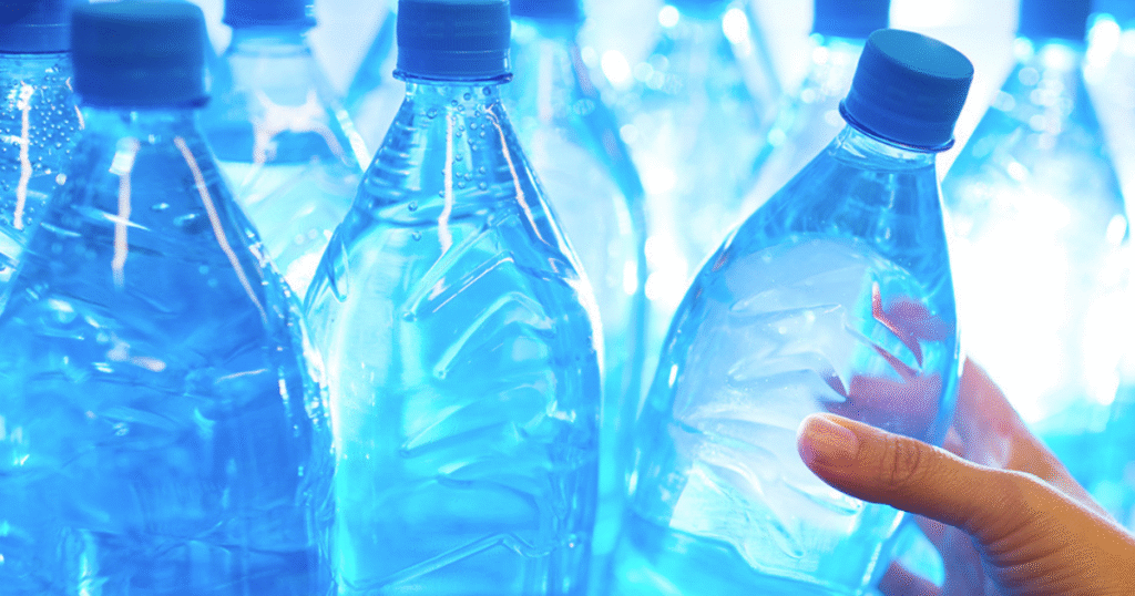 A person holding a bottle of water, highlighting the topic of bottled water expiry dates.